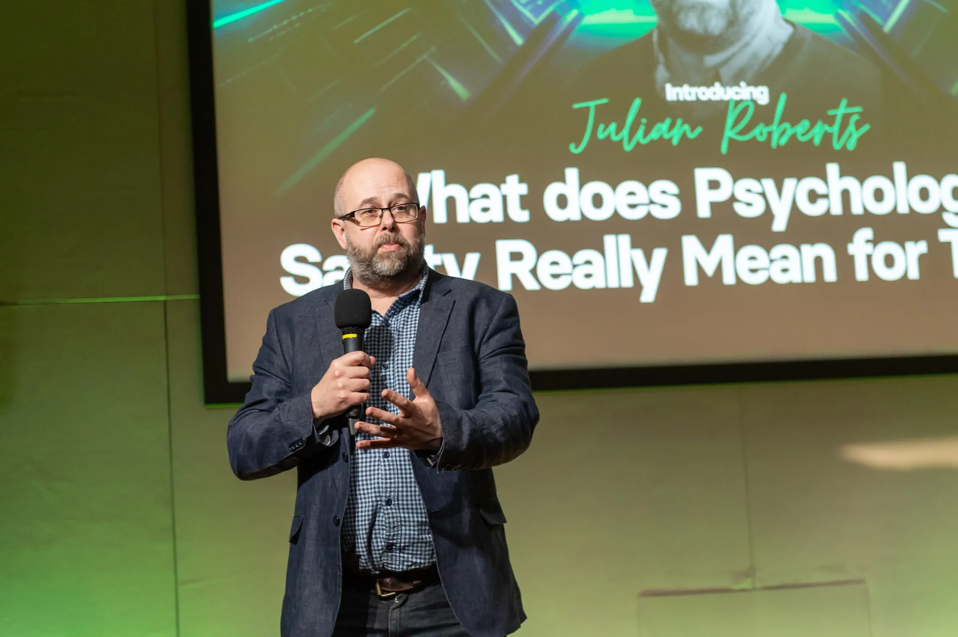 A speaker on stage at the 2026 National Coaching Conference
